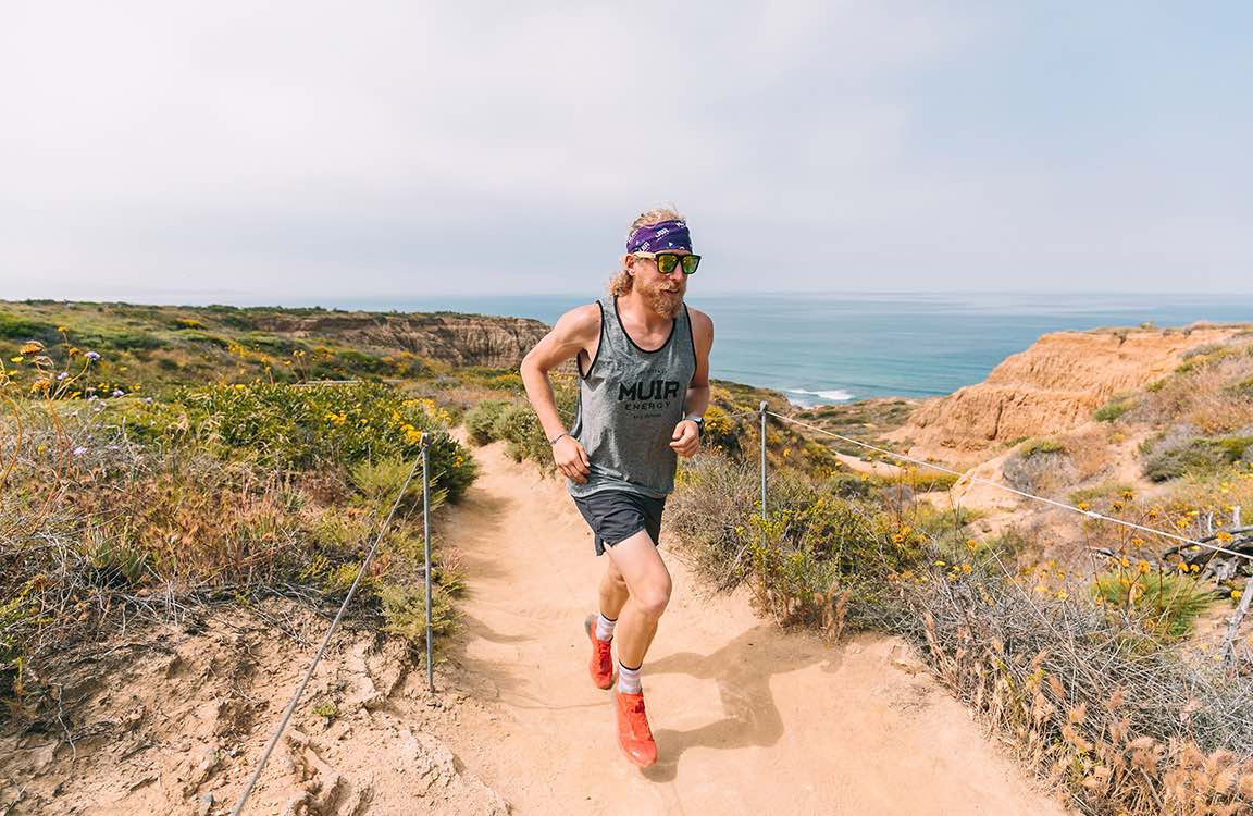 ultrarunner Avery Collins running along coast